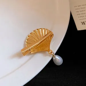 Elegant gold shell hair clip with teardrop pearl pendant for vintage vacation style