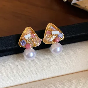 Detailed view of vintage-style 18k gold plated earrings with crystals and pearls