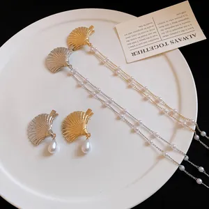 Elegant shell shaped hair clips with dangling pearls and long pearl tassels in gold and silver