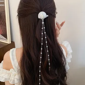 Elegant silver shell hair clip featuring long dainty pearl chain tassels on model hair