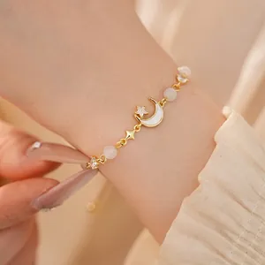 Elegant gold moon and star bracelet with cat's eye stones and zircons for women.