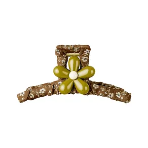 Forest style floral fabric hair claw clip with a glossy olive green flower decoration