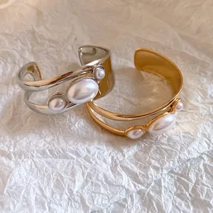 Retro gold and silver plated hollow cuff bracelets featuring elegant oval pearl details