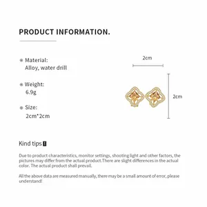 Detailed view of 2cm gold flower earrings with orange stones and rhinestone pavé