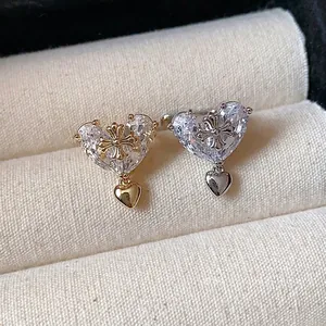 Luxurious 18k gold plated heart zircon ear clips with cross motif for women.