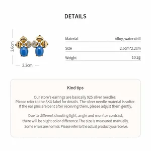 Detailed view of luxury vintage flower earrings with blue oval stones and crystals.