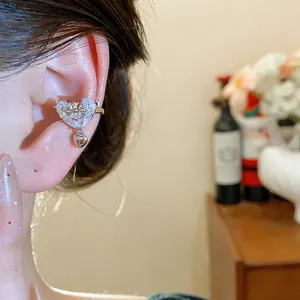 Elegant 18k gold plated heart ear cuff with cubic zirconia and a delicate cross motif