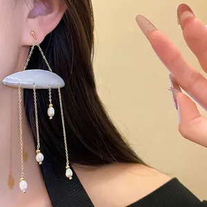 Elegant shell and freshwater pearl tassel earrings with silver needle, holiday style.