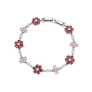 Silver-toned bracelet featuring red zircon flowers and pink cross motifs