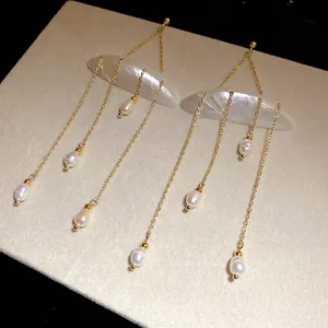 Elegant shell and freshwater pearl tassel earrings with gold chain in resort style