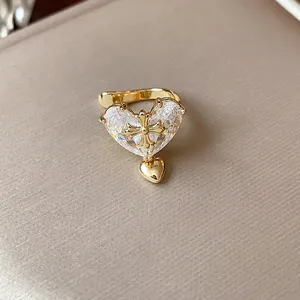 Exquisite detail of a gold-plated heart zircon ear cuff featuring a unique cross motif