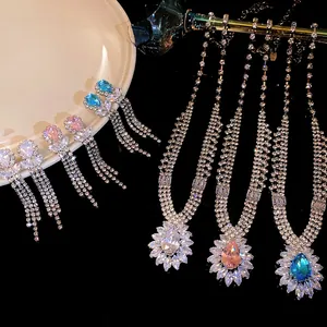 Close-up of elegant water drop zircon jewelry sets in blue, pink, and clear crystal colors.
