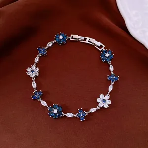 Detailed macro shot of an elegant silver bracelet with blue and white floral zircon stones