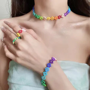 Bohemian style rainbow beaded flower jewelry set worn by a model.