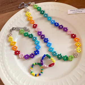 Close-up detail of Bohemian colorful seed bead daisy flower necklace and ring jewelry set