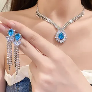 Macro view of sparkling blue teardrop zircon necklace and tassel earrings set for women
