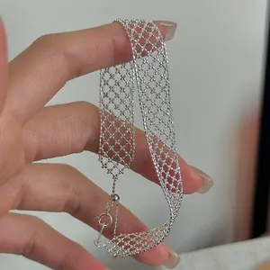 Close-up of elegant silver hollow mesh bracelet with a delicate lattice texture