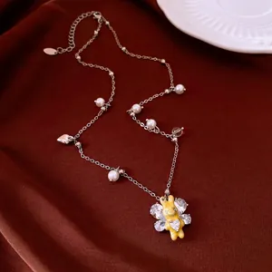Elegant silver-tone necklace with yellow rabbit pendant, pearls, and sparkling zircons