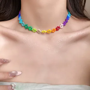 Detailed view of a Bohemian rainbow beaded flower choker necklace worn by a model