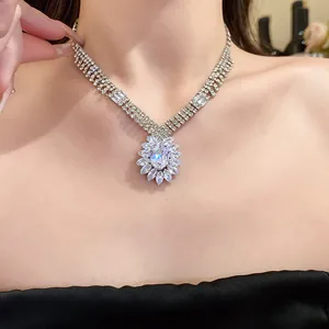 Exquisite close-up of a sparkling water drop zircon flower pendant necklace on a model