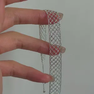Macro view of the intricate silver hollow mesh lattice bracelet with cross pattern.