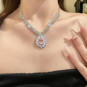 Detail view of a luxury zircon waterdrop pendant necklace on model's neck