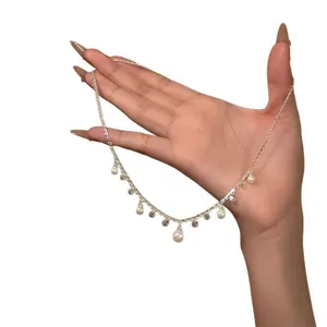 Detail view of a Korean-style necklace with pearl drops and sparkling zirconia
