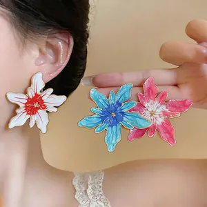 Detailed view of colorful enamel flower stud earrings for a bold and artistic look