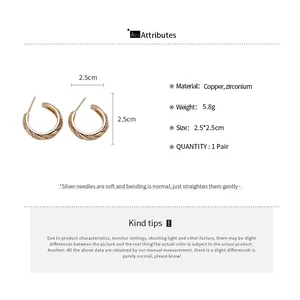 Macro view of gold plated wheat ear stud earrings with zircon details and size specs