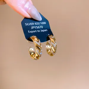 Detailed macro view of 14k gold plated zircon earrings with vintage wheat ear design