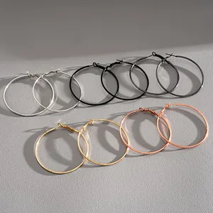 Detailed display of minimalist metallic hoop earrings in various elegant finishes.
