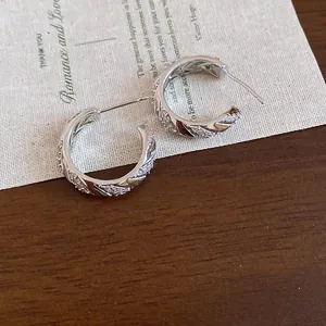 Detailed macro view of 14k gold plated wheat pattern hoop earrings with zircons