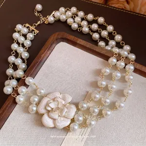 French vintage triple-strand pearl necklace with elegant enamel camellia flower charm