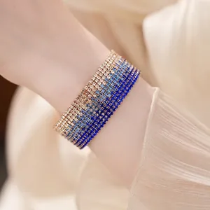 Elegant multi-layer gradient blue and white rhinestone elastic cuff bracelet on wrist