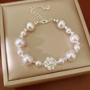 Elegant pink pearl bracelet featuring a sparkling zircon flower center and adjustable chain
