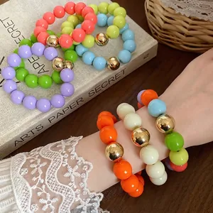 Oversized colorful chunky bead bracelet and necklace set featuring unique gold metallic beads