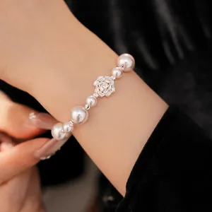 Elegant pearl beaded bracelet featuring a sparkling zircon flower centerpiece for a luxurious look