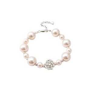Elegant pearl bracelet featuring a sparkling zirconia flower center and adjustable chain