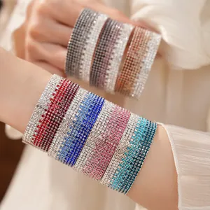 Detailed macro shot of multi-layer gradient rhinestone elastic bracelets on wrist