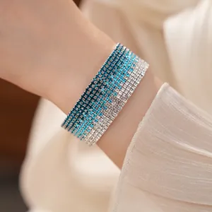 Close-up of multi-layer stretch bracelet with blue gradient rhinestone details