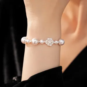Elegant pearl and zircon flower beaded bracelet detail shown on a model's wrist