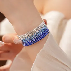Detailed close-up view of a multi-layer gradient blue rhinestone elastic bracelet on wrist