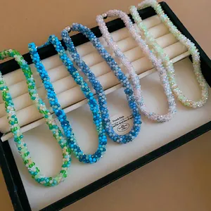 Detailed view of multiple woven beaded crystal necklaces in various vibrant colors