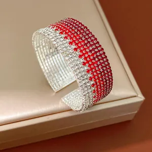 Close-up view of a multi-layer gradient rhinestone cuff bracelet with a sparkling finish