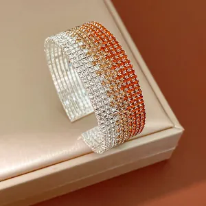Detailed view of a multi-row rhinestone cuff bracelet with orange and white gradient