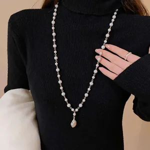 Detail view of a vintage Baroque long necklace featuring irregular imitation pearl pendant