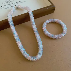 Detailed view of pink and blue woven crystal beaded necklace and bracelet set.