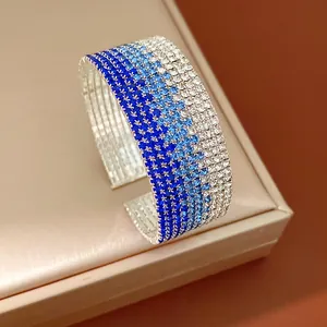 Close-up detail of multi-layer stretch cuff bracelet with blue gradient rhinestones
