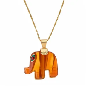 Elegant Bohemian style orange resin elephant pendant necklace on a gold twisted chain