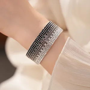 Detailed macro view of a multi-layer gradient rhinestone elastic bracelet on a wrist
